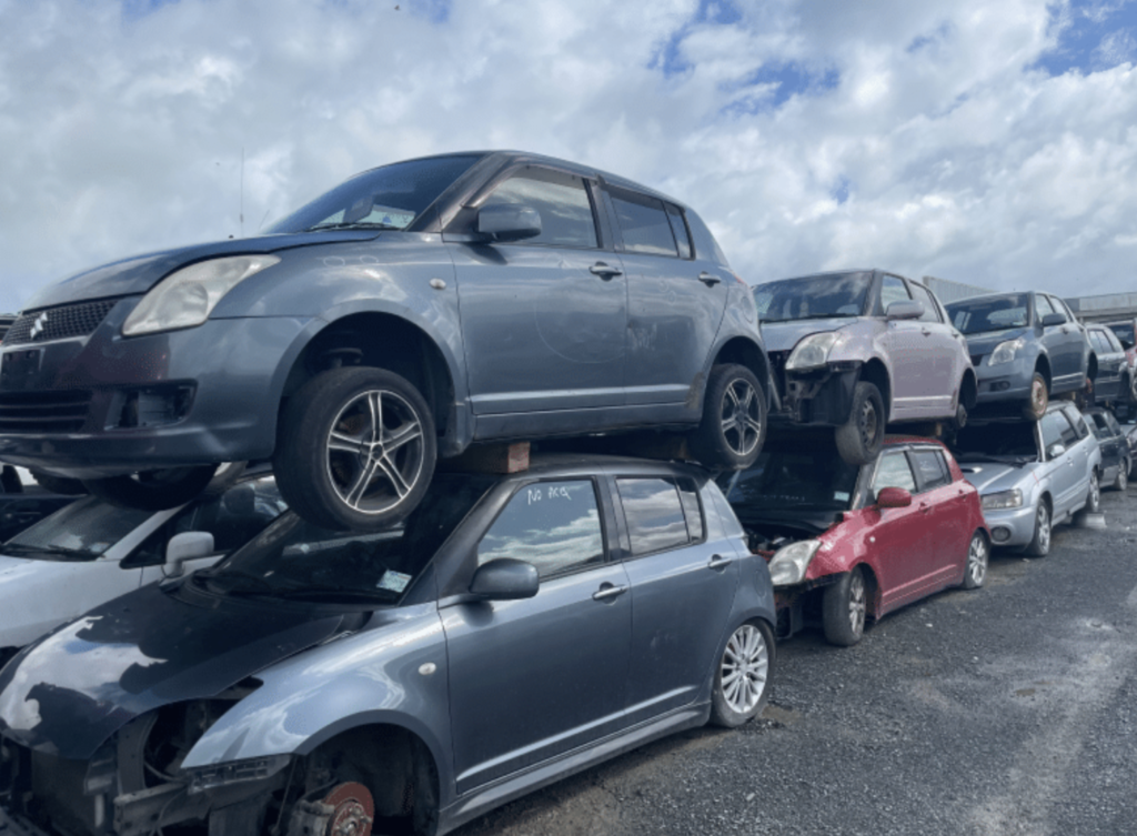 Old scrap car being loaded onto a truck for removal in Palmerston North.