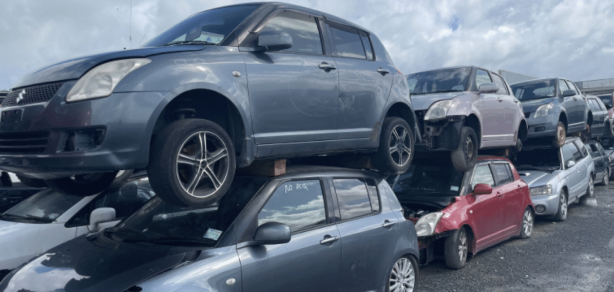 Old scrap car being loaded onto a truck for removal in Palmerston North.
